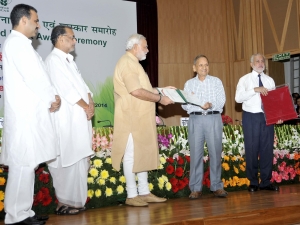 Prime Minister of India Sh. Narinder Modi honouring Bhagwan Dass Secretary General of the Association with an ICAR Award. Director General ICAR & Secretary DARE Govt. of India and Sh. Radhe Mohan Singh Union Agriculture Minister are also standing in the picture.